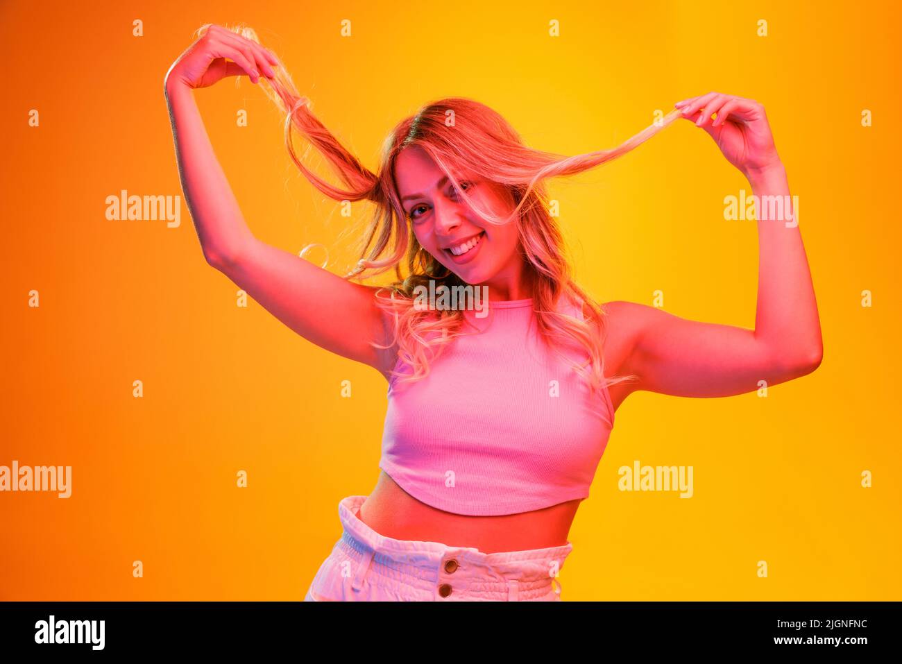 Portrait of young beautiful woman posing isolated over yellow ...