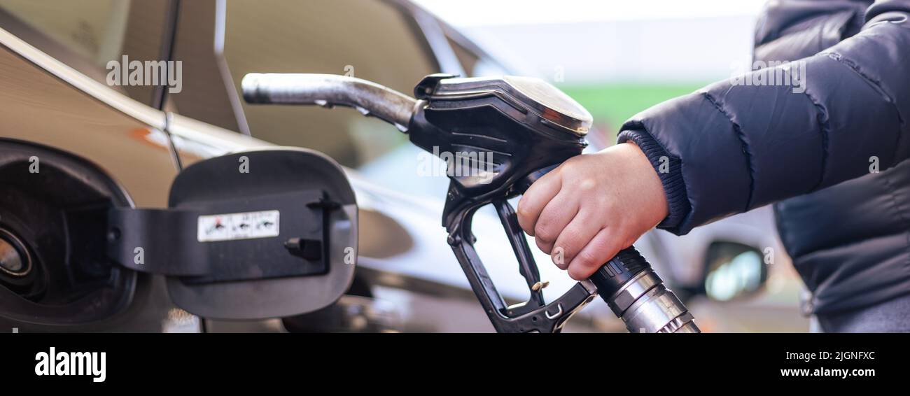 Refueling the car at a gas station fuel pump, car refueling on petrol