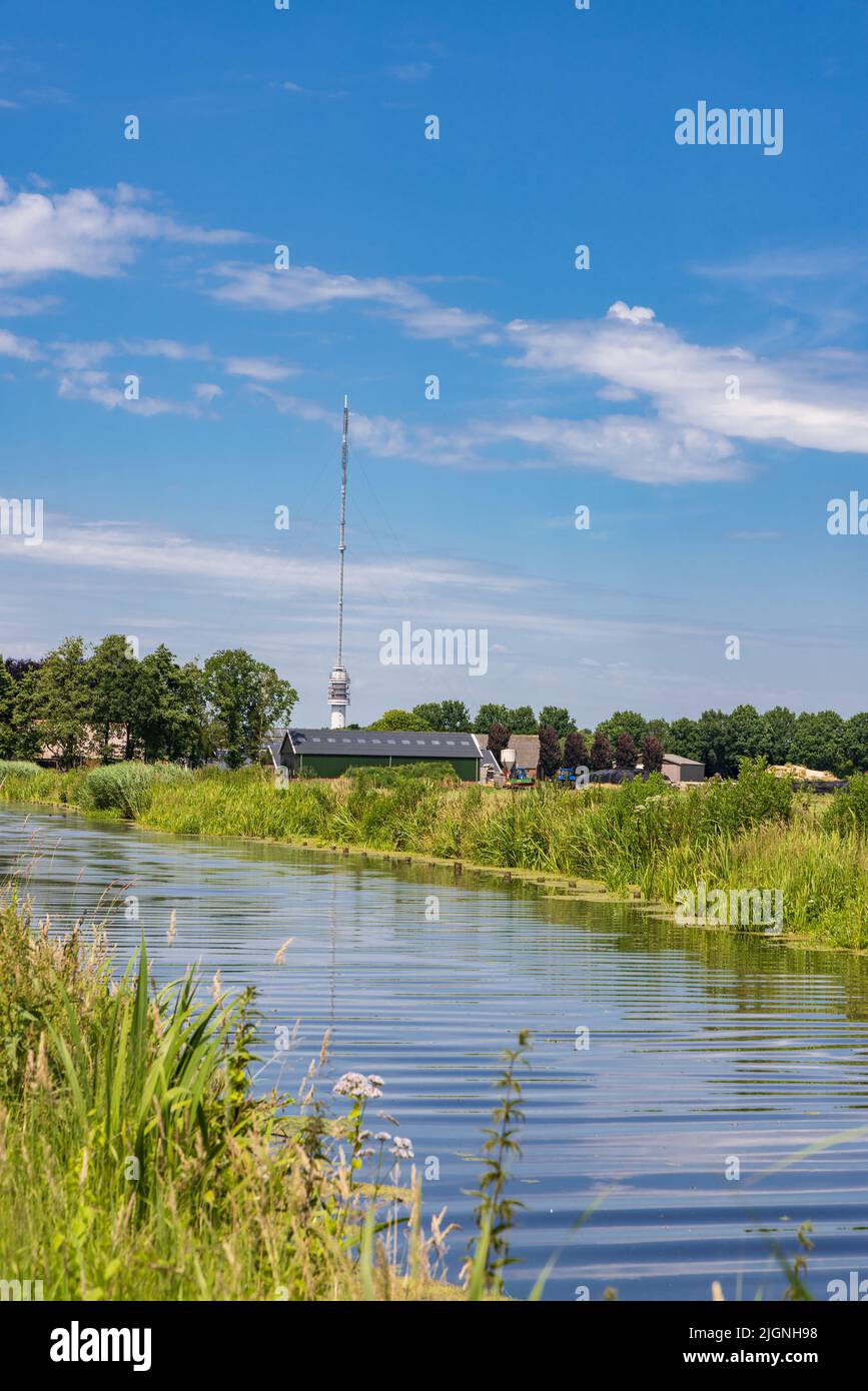 Landscape with Beilervaart and transmission tower Smilde in the backgroundThe Netherlands Stock Photo