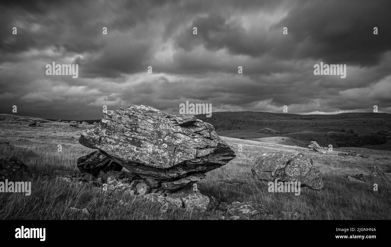 A stormy day at the Norber Erratics, one of the finest groups of glacial erratic boulders in the UK, close to the village of Austwick, in the Yorkshir Stock Photo