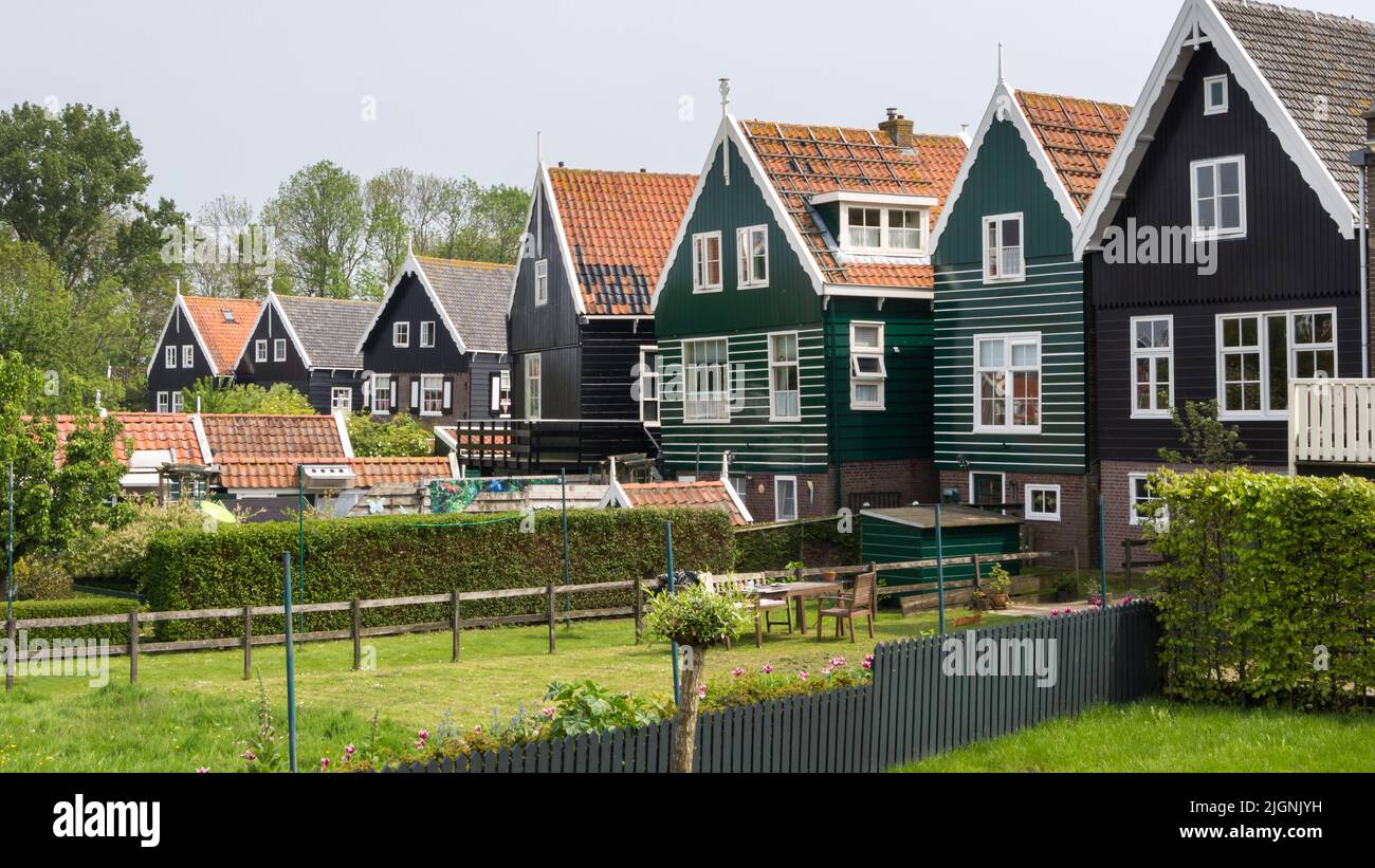 Historic Dutch fishermen village with green wooden houses called Marken Stock Photo