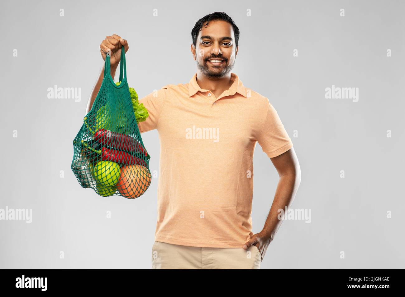 happy indian man with food in reusable net tote Stock Photo