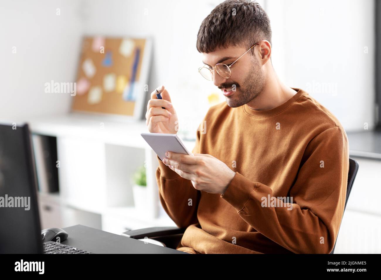 man in glasses with notebook working at office Stock Photo