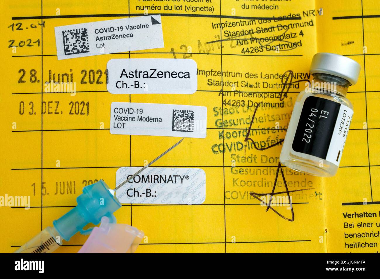 Syringe on a German vaccination card with the note of four vaccinations against Covid-19, booster vaccination - 07/12/2022 Stock Photo