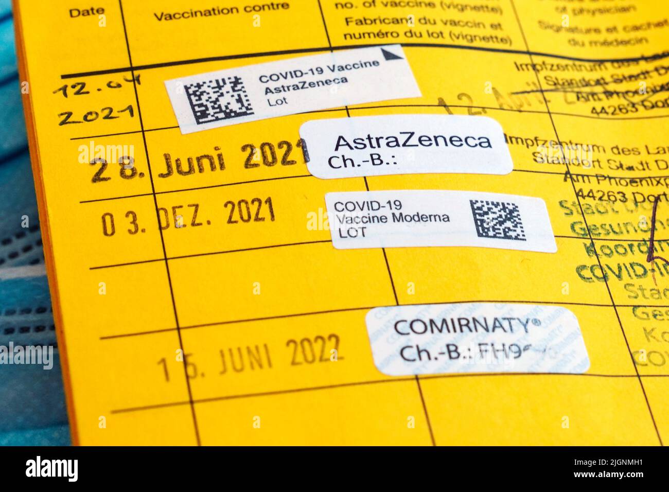 German vaccination card with the note of four vaccinations against Covid-19, booster vaccination - 07/12/2022 Stock Photo