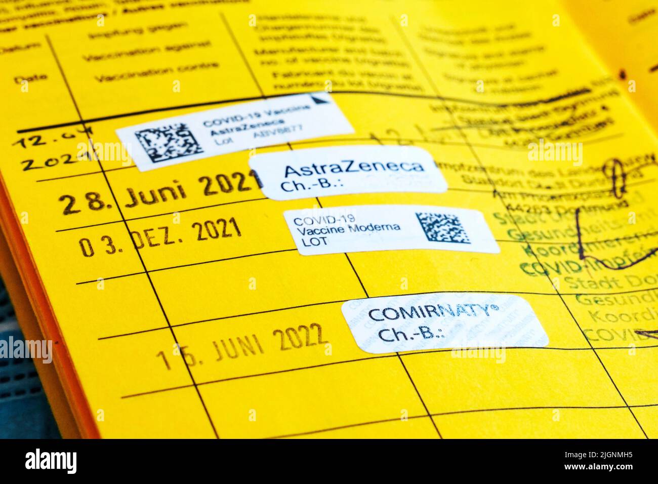 German vaccination card with the note of four vaccinations against Covid-19, booster vaccination - 07/12/2022 Stock Photo