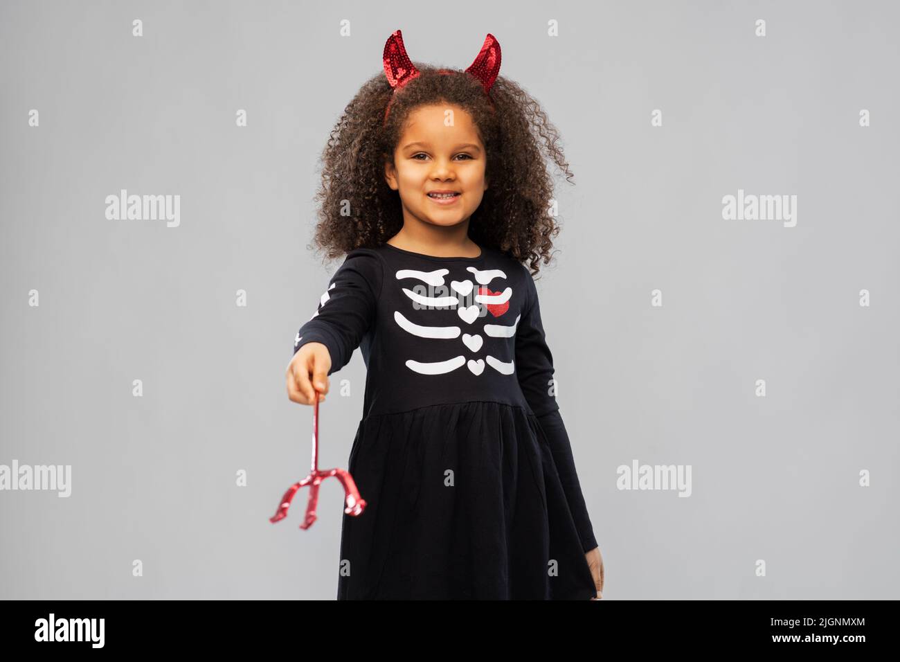 girl with trident and devil's horns on halloween Stock Photo