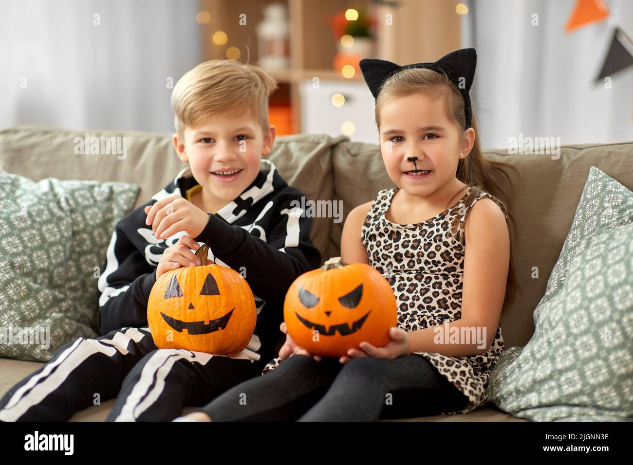 kids-in-halloween-costumes-with-pumpkins-at-home-stock-photo-alamy