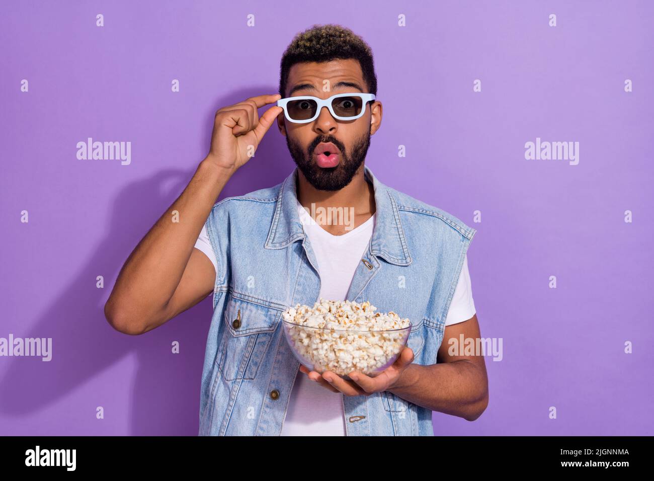 Photo of excited impressed man wear jeans waistcoat dark glasses enjoying  pop corn isolated violet color background Stock Photo - Alamy