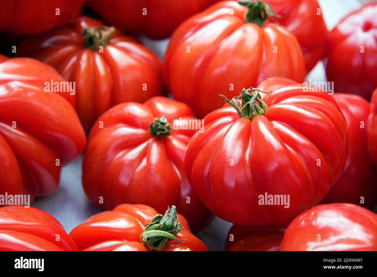 Fresh ripe tomatoes displayed for sale at a market Stock Photo