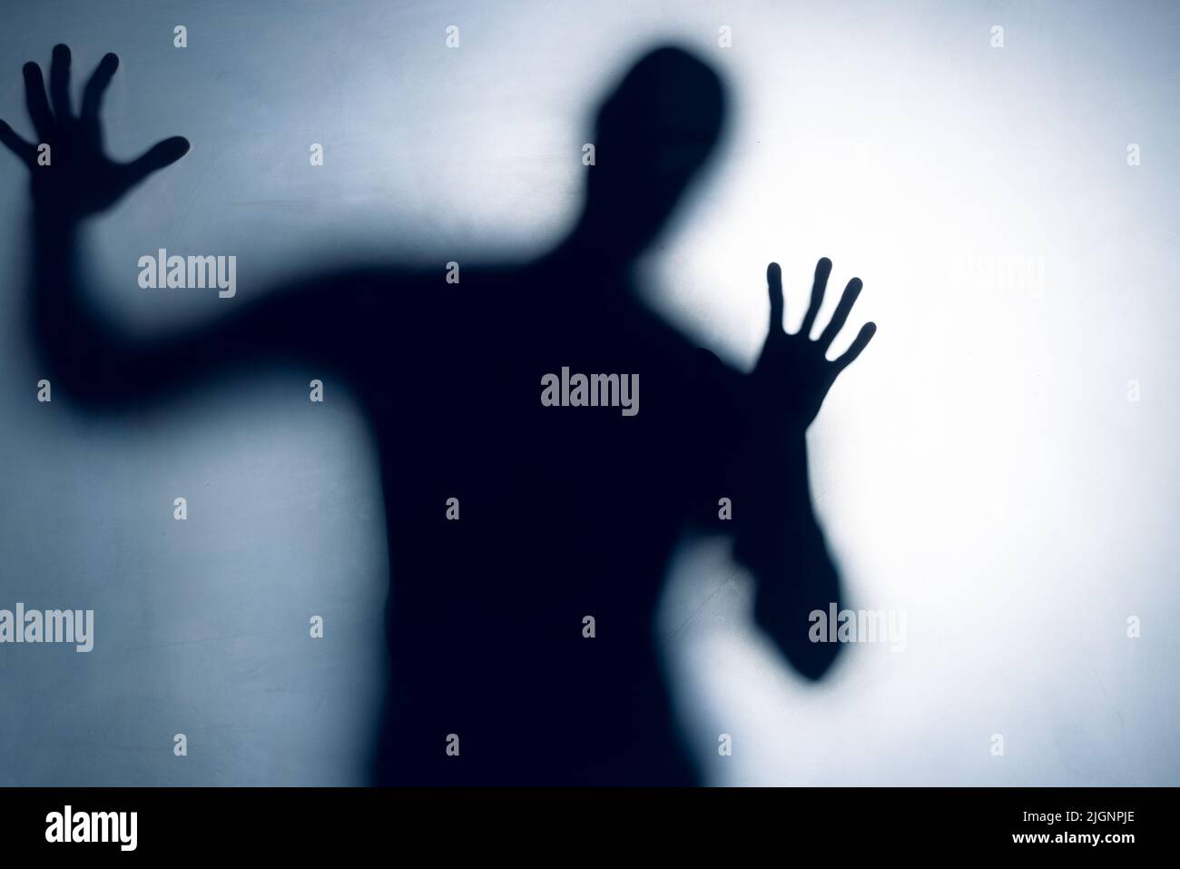 Composition of black silhouette of man with shadows on white background Stock Photo