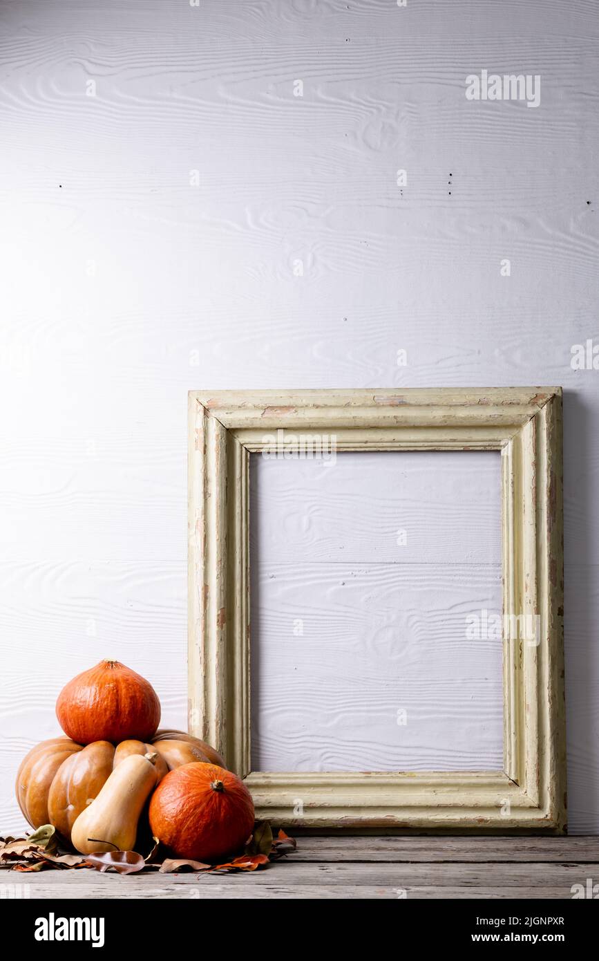 Composition of pumpkins with autumn leaves and frame with copy space on ...