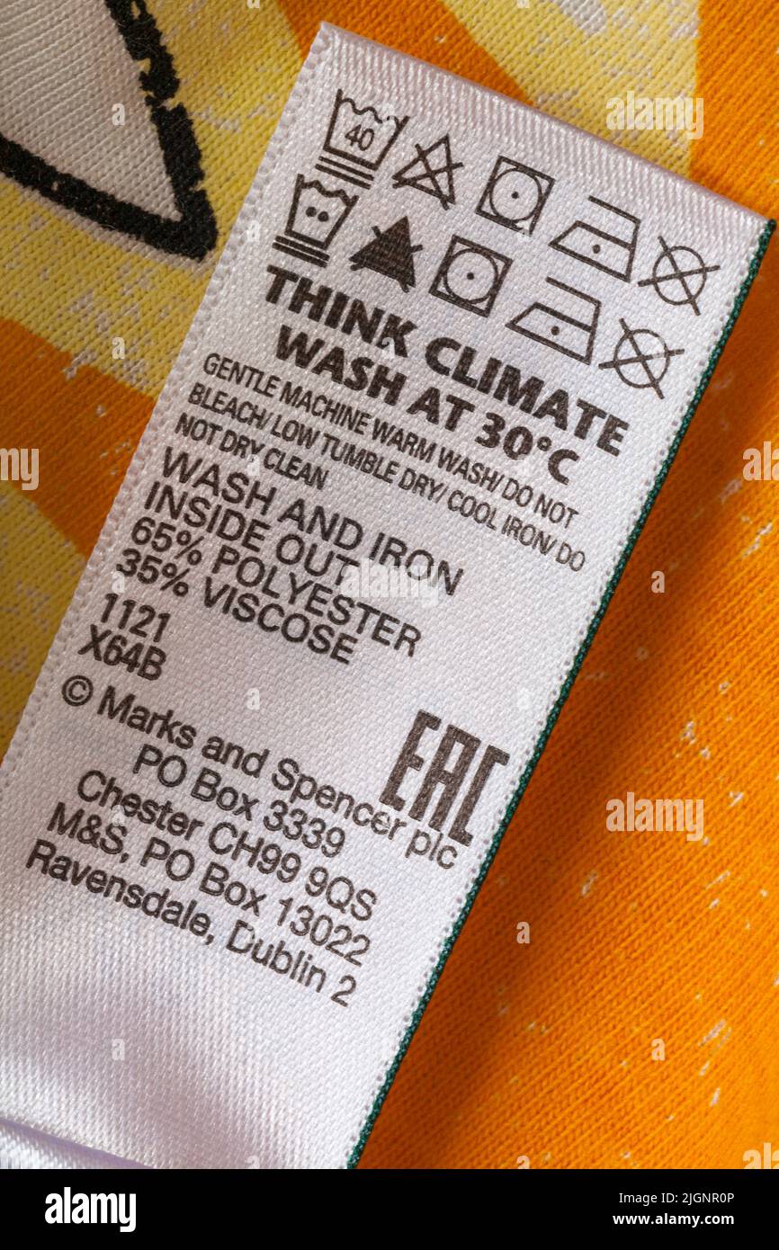 Care washing symbols and instructions on label in Marks and Spencer t-shirt - think climate wash at 30 degrees Stock Photo