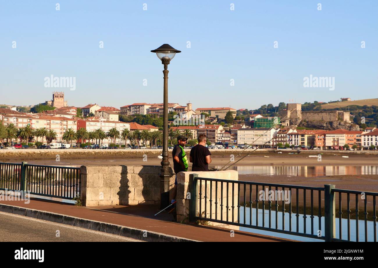 Men rod and line fishing from the Maza road bridge in the Spanish town San Vicente de la