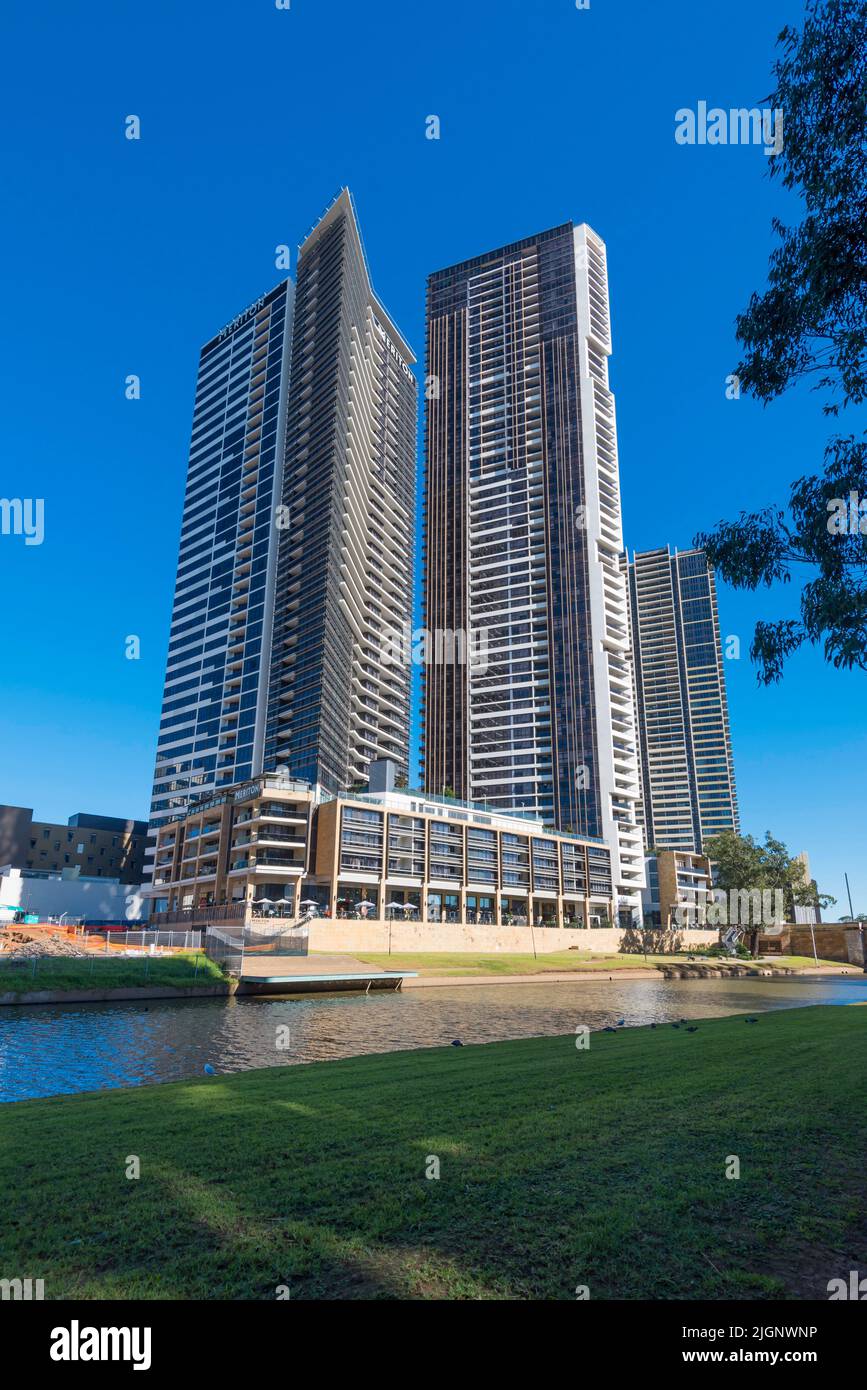 With retail and restaurants on lower levels, the Meriton Suites hotel is situated on Chruch Street beside the river in Parramatta, Australia Stock Photo