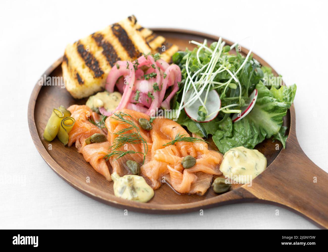 salmon gravlax platter with salad and toast on white background in sweden Stock Photo
