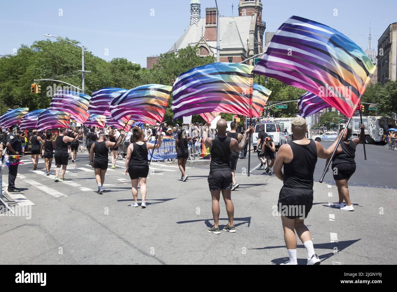 The annual Gay Pride Parade returns to march down 5th Avenue  and end up on Christopher Street in Greenwich Village after a 3 year break due to the Covid-19 pandemic. Group of flag dancers crossing 6th Ave, to Christopher Street. Stock Photo