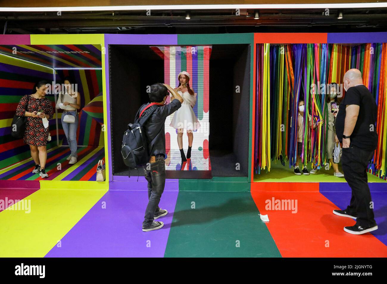 People take pictures inside a booth with rainbow colors at a shopping mall in Bangkok. Lawmakers in Thailand gave initial approval to legalizing same-sex unions, a step closer towards becoming the second territory in Asia to legalize same-gender marriages. Thailand. Stock Photo