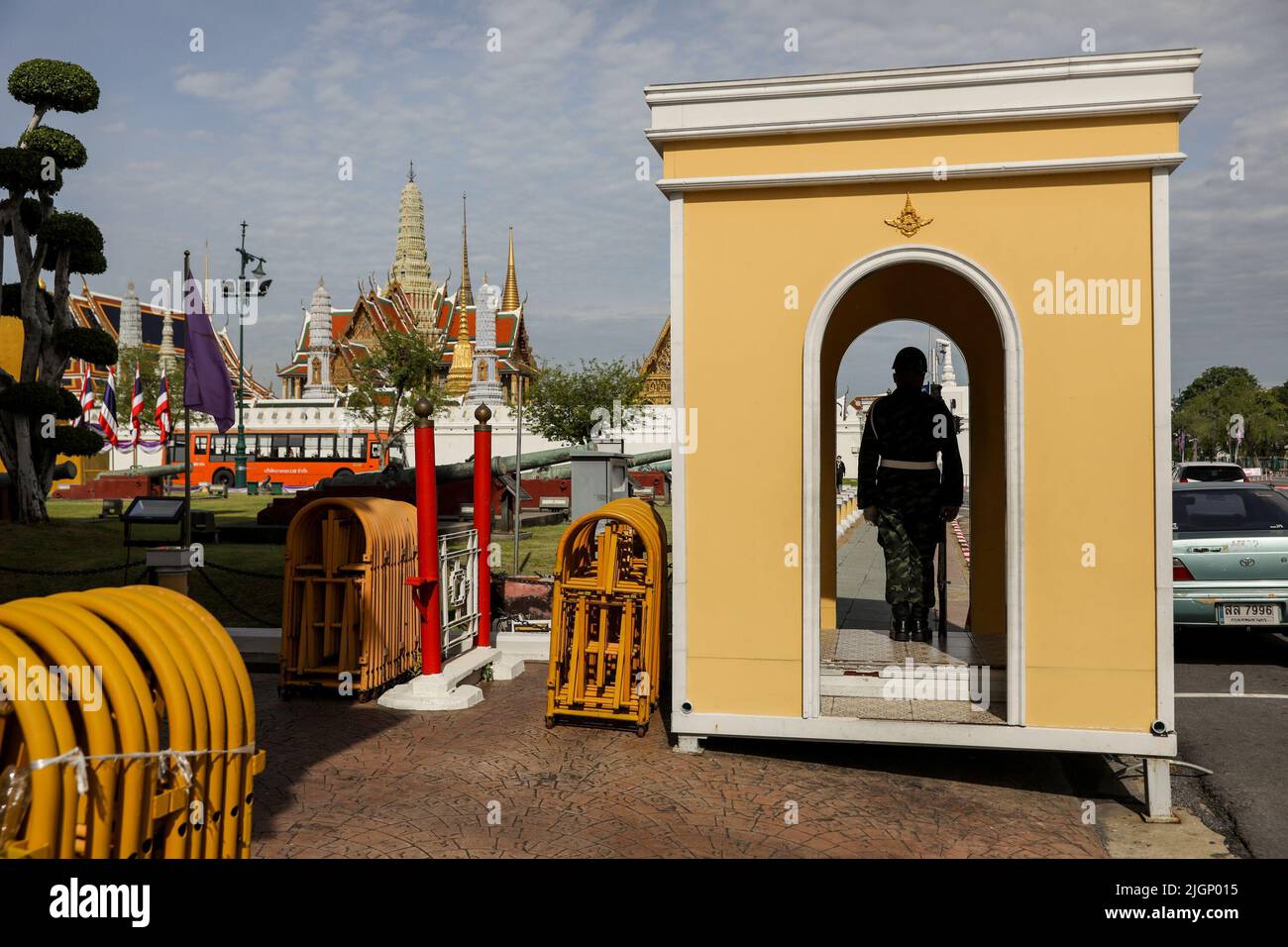 A policeman patrols outside a temple inside the Grand Palace in Bangkok. Thailand continues to ease restrictions to boost its tourism despite the a global pandemic and new waves of coronavirus cases. Thailand. Stock Photo