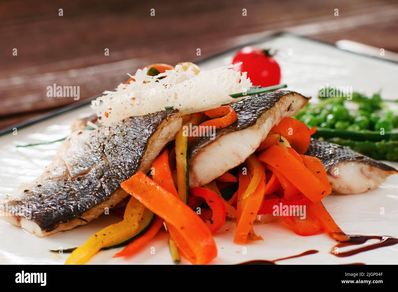 Grilled fish fillet with carrot closeup Stock Photo Alamy