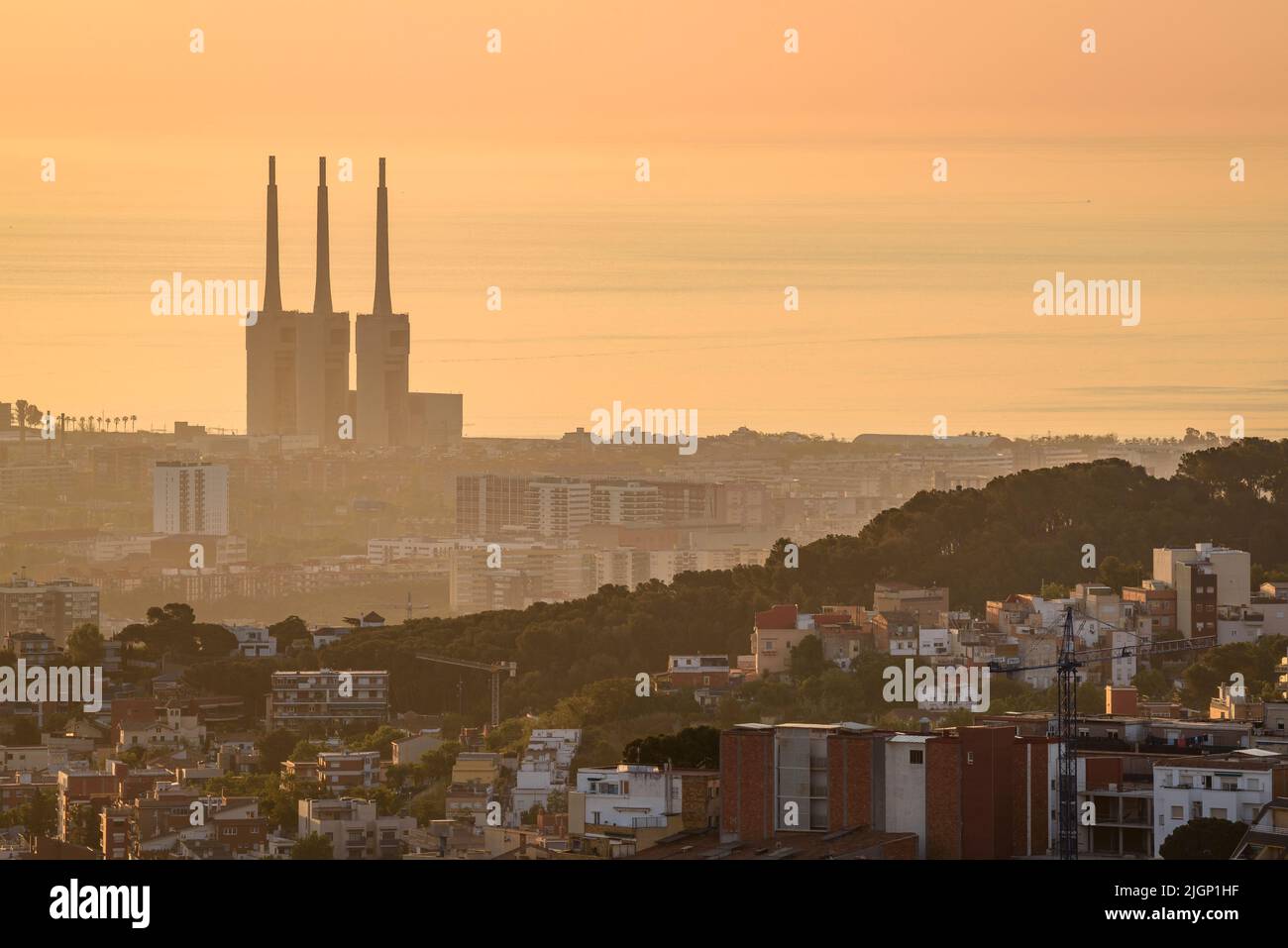 Sunrise over Barcelona region seen from the Tibidabo mountain. In the background, the Sant Adrià de Besòs Thermal power station (Barcelona, Spain) Stock Photo