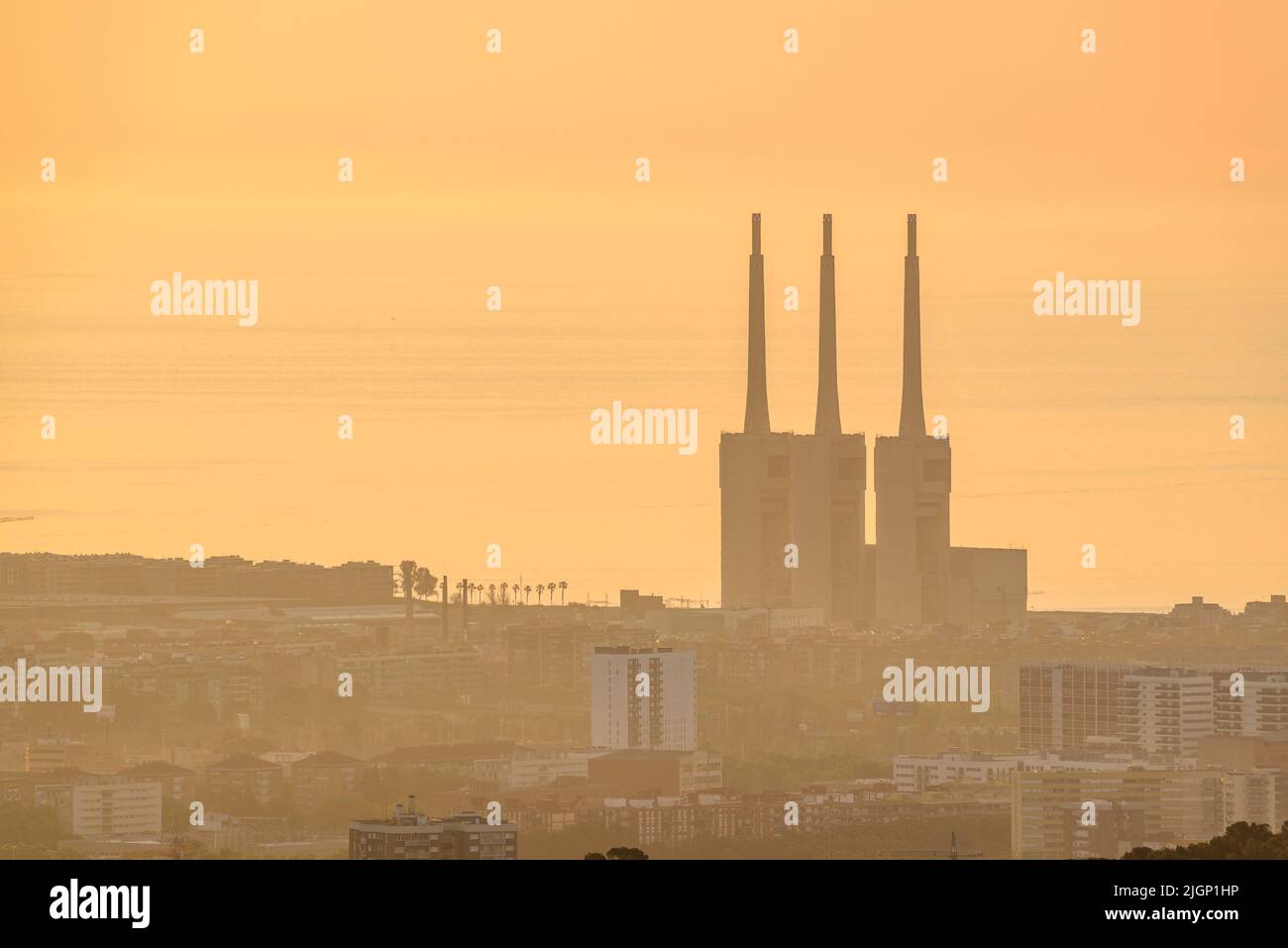 Sunrise over Barcelona region seen from the Tibidabo mountain. In the background, the Sant Adrià de Besòs Thermal power station (Barcelona, Spain) Stock Photo