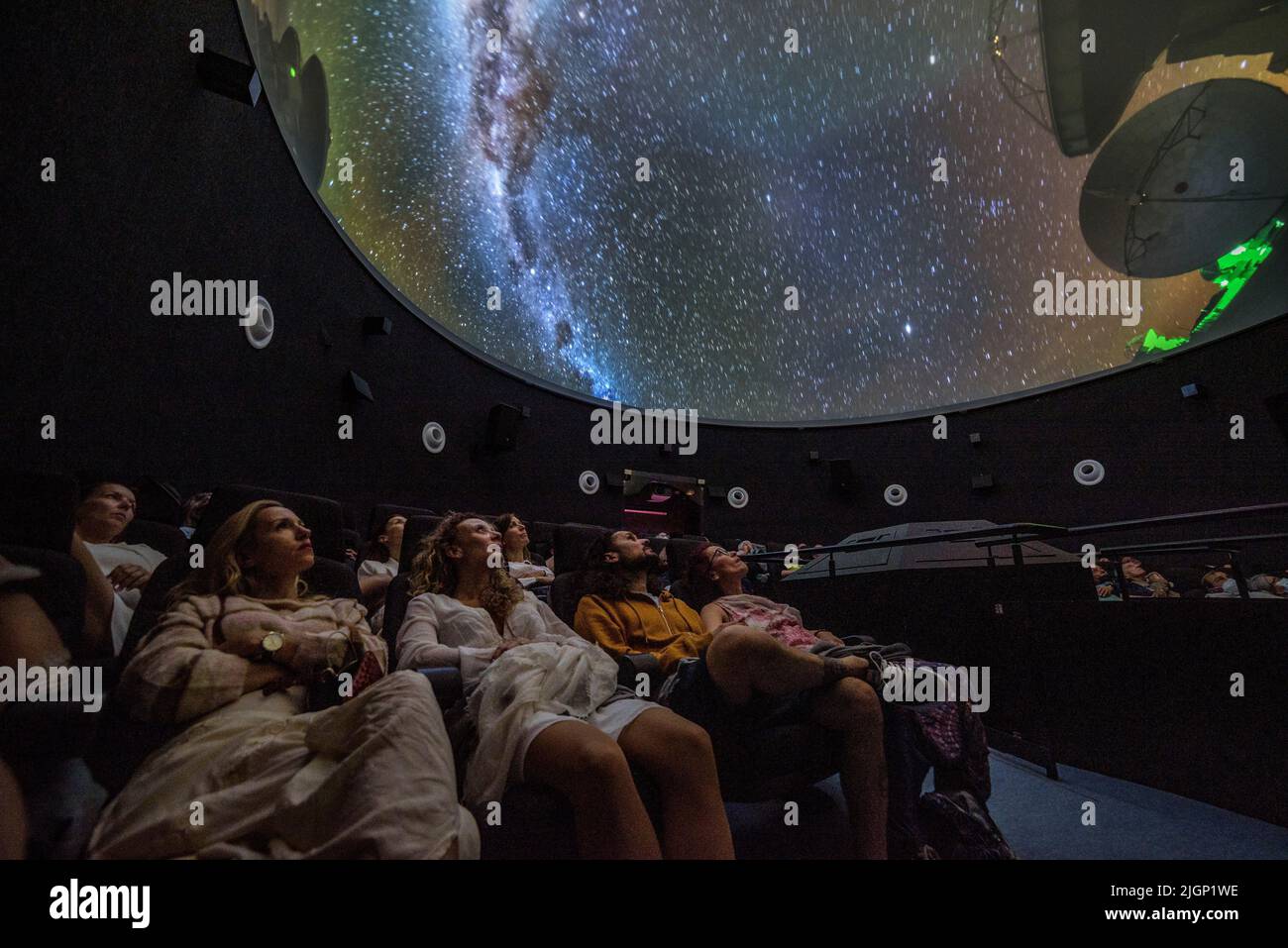 Tourists at the 'Ull del Montsec' planetarium during the projection of the video about the night, the Milky Way and astronomy (Àger, Lleida, Spain) Stock Photo