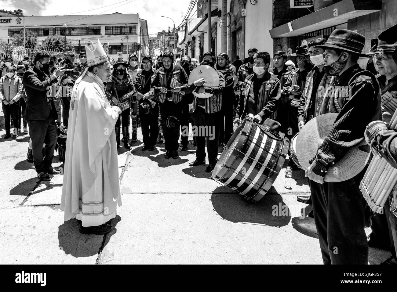 A Catholic Priest Blesses A Musical Band After An Outdoor Mass In The Plaza De Armas, Puno, Puno Province, Peru. Stock Photo