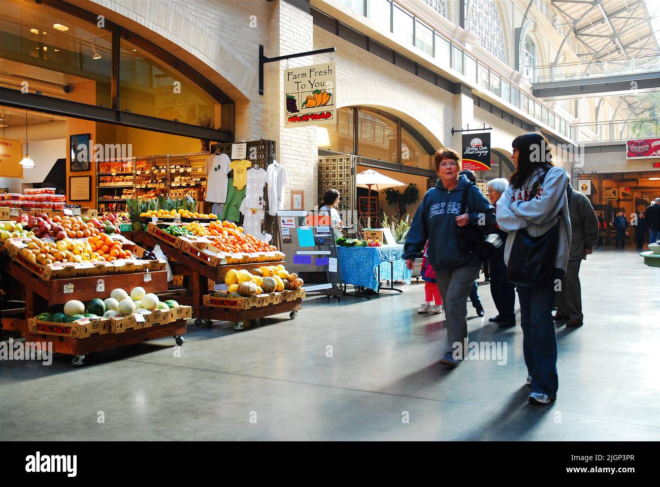 Customer stroll through the interior hall of the historic Ferry Building in San Francisco where