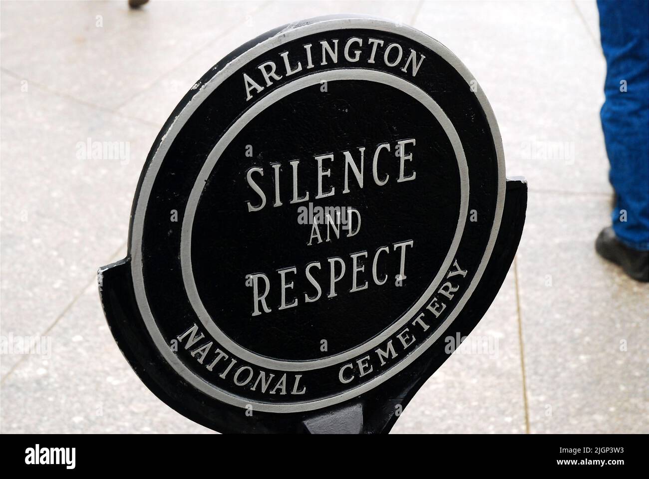 A sign at the Arlington National Cemetery in Arlington, near Washington DC requests that visitors refrain from loud noise and show respect and silence Stock Photo