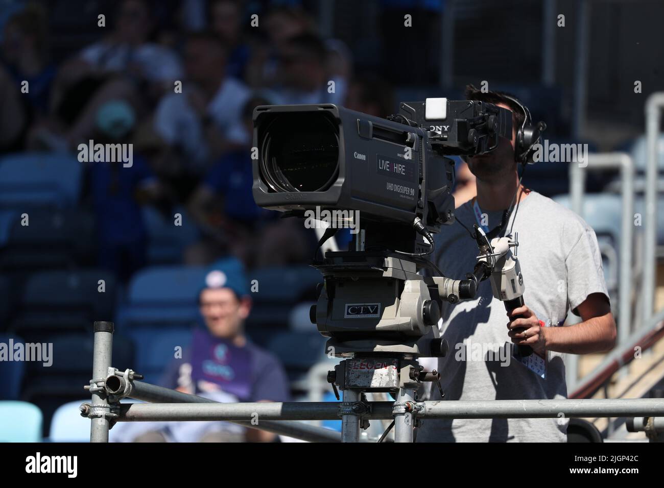 Canon TV Broadcast Camera and male Operator on scaffold gantry platform at Sports Event Stock Photo