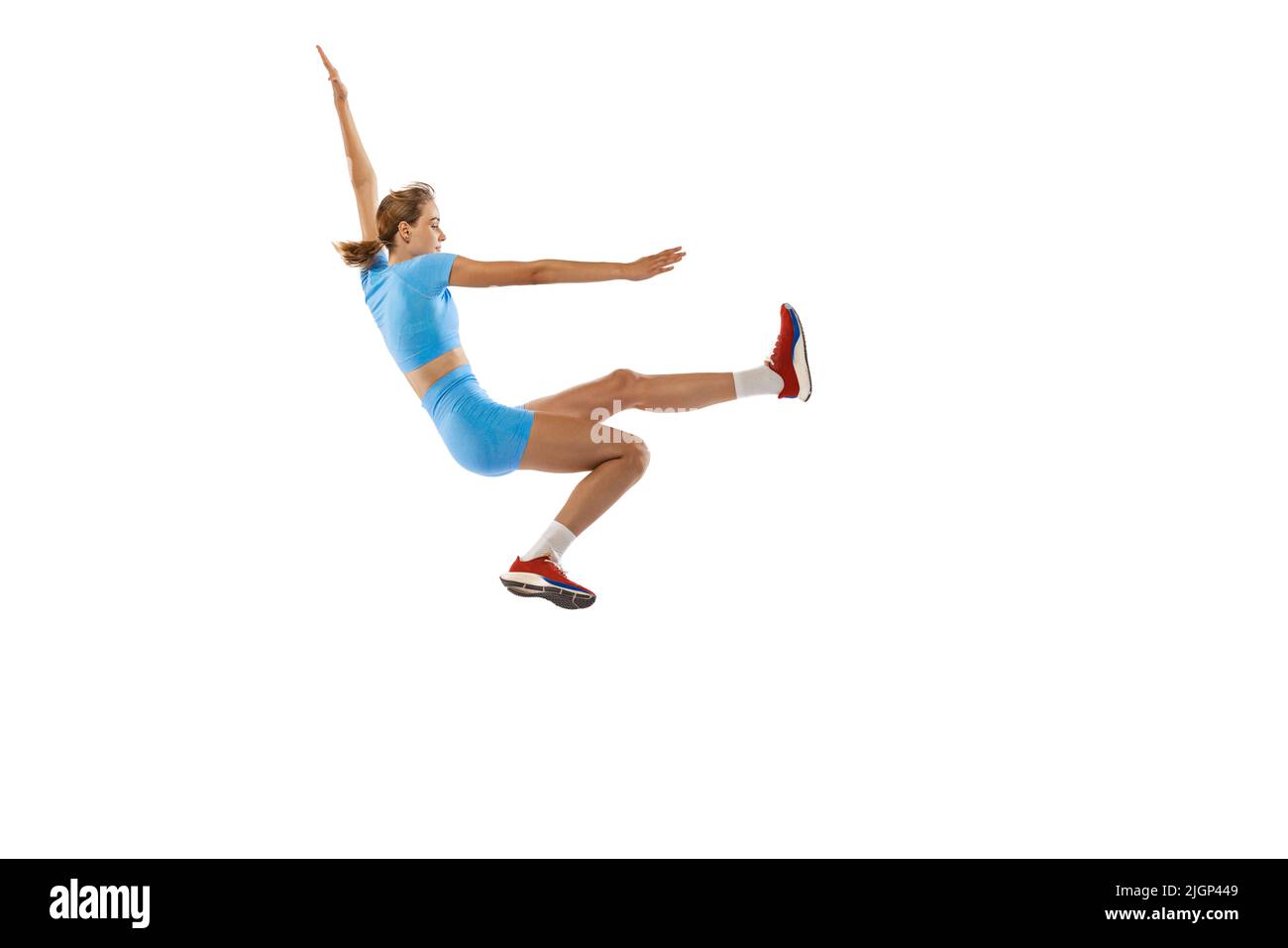 Triple jump technique. Studio shot of female athlete in sports uniform