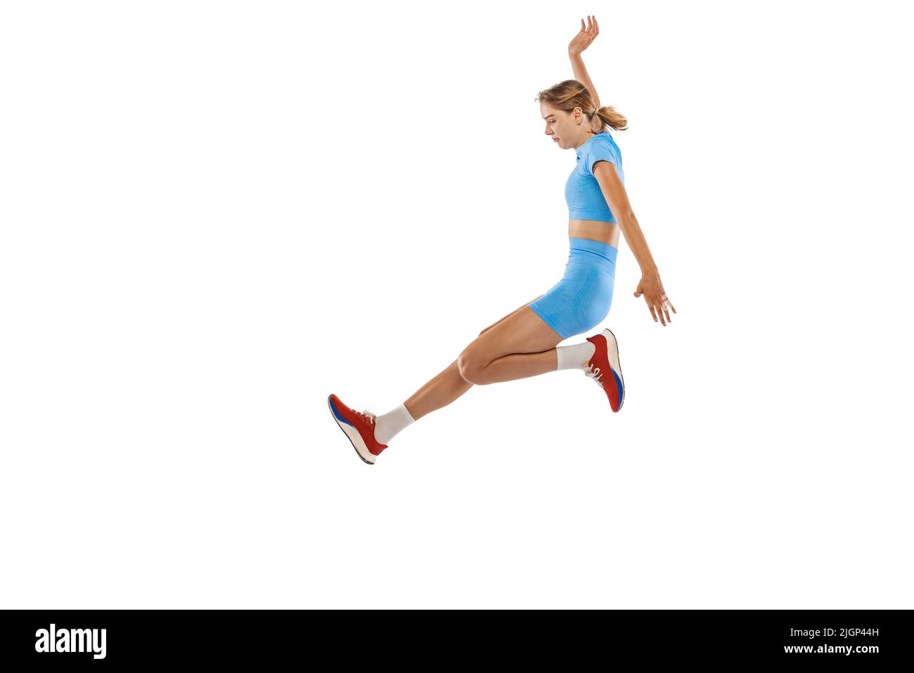 Triple jump technique. Studio shot of female athlete in sports uniform