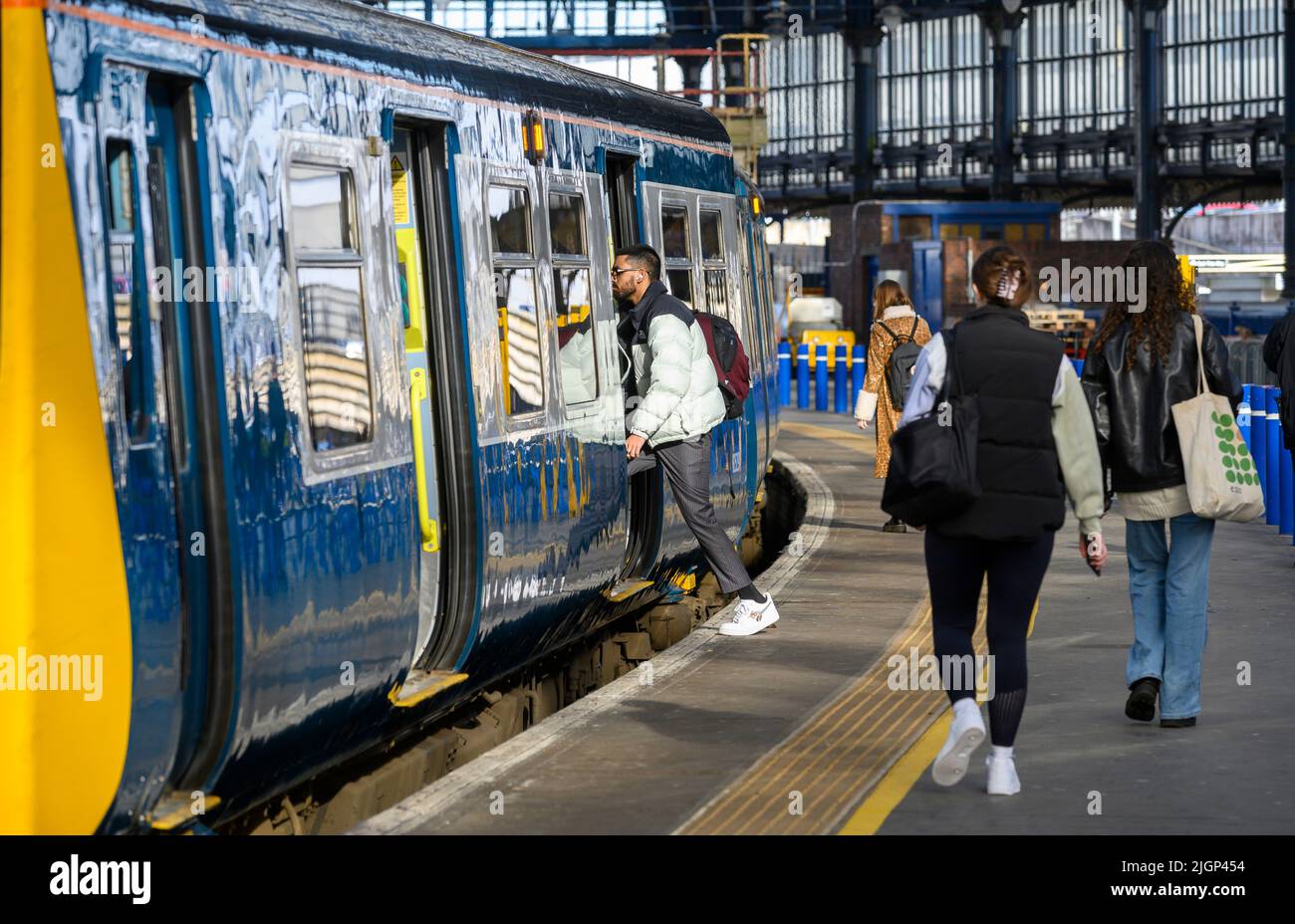 Passengers boarding a British Rail class 313 train in Southern livery, Brighton Railway Station, England. Stock Photo