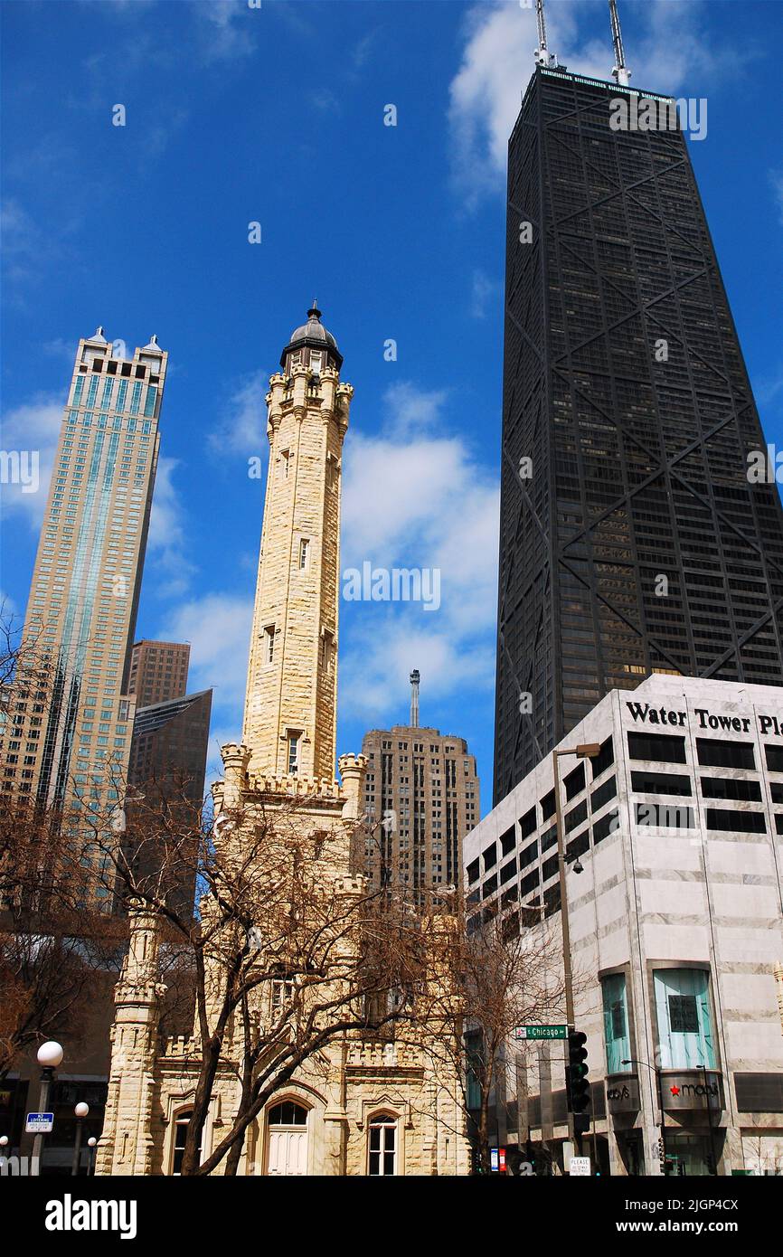 The modern John Hancock Center skyscraper contrasts with the historic stone Water Tower on Michigan Avenue in Chicago, Illinois Stock Photo