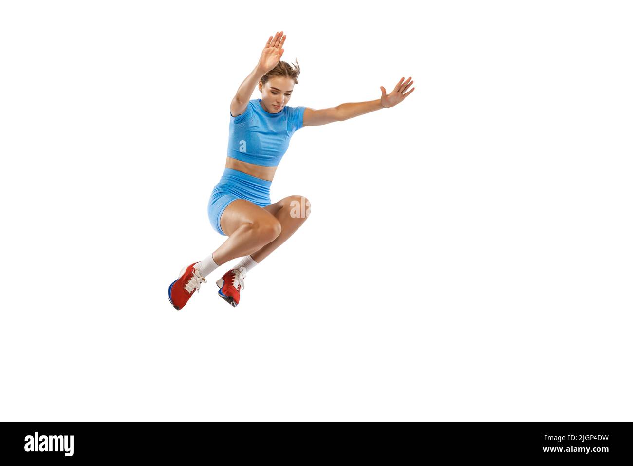 Triple jump technique. Studio shot of female athlete in sports uniform