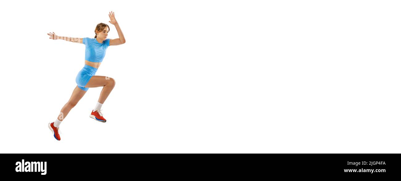 Triple jump technique. Studio shot of female athlete in sports uniform