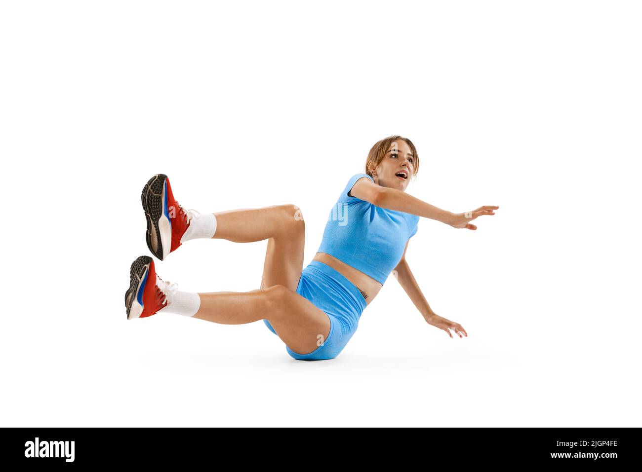 Triple jump technique. Studio shot of female athlete in sports uniform