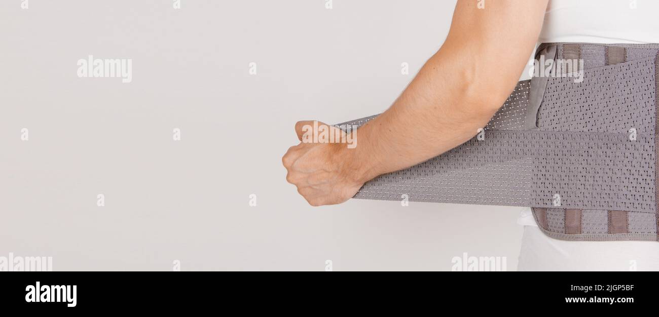Lumbar brace on the human body isolated on a white background. Trauma