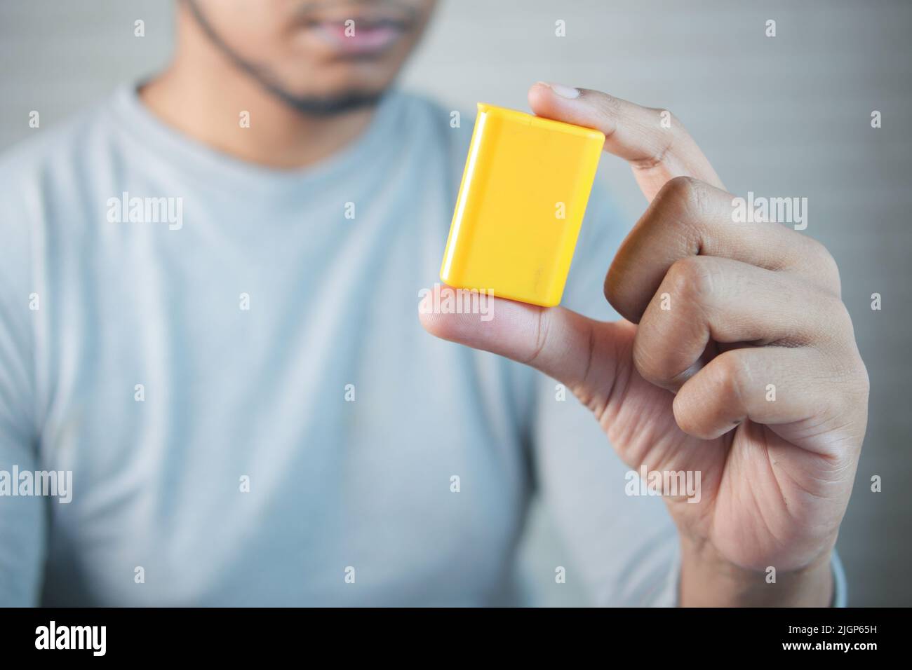 young man putting artificial sweetener in tea, Stock Photo
