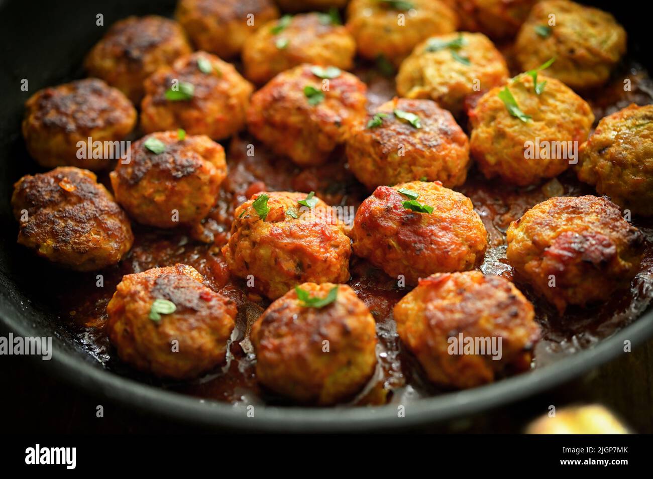 Closeup Meatballs and Tomato Sauce in Pan on table Stock Photo