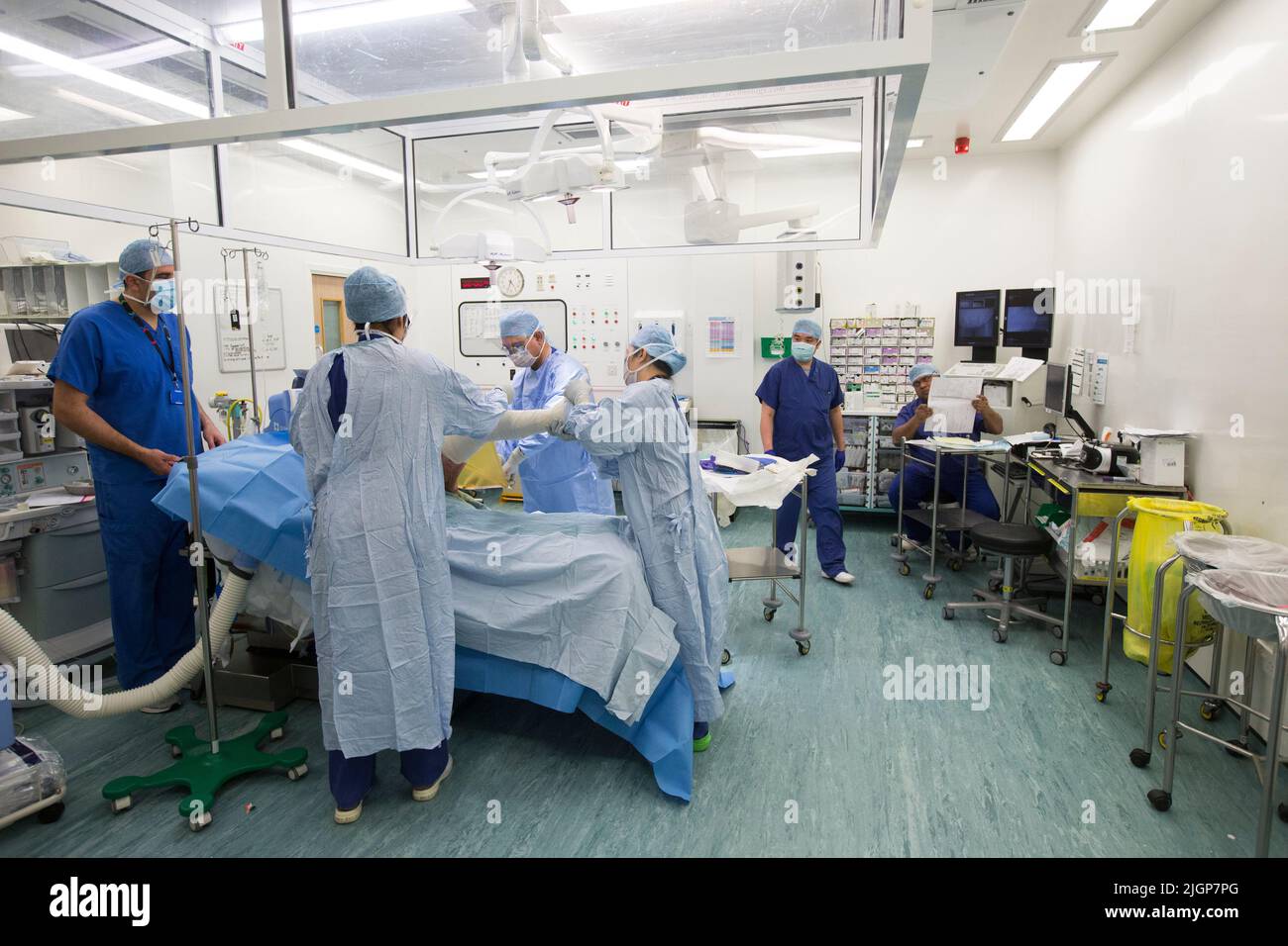 Hospital staff prepare a patient for foot surgery. The NHS is under pressure following severe cuts and staff shortages. Stock Photo