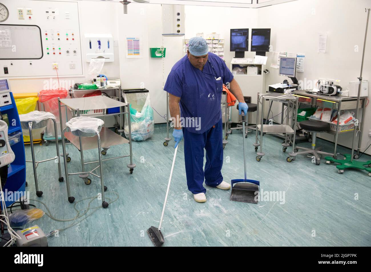 An NHS worker cleans an operating theatre before an operation. Cleaning