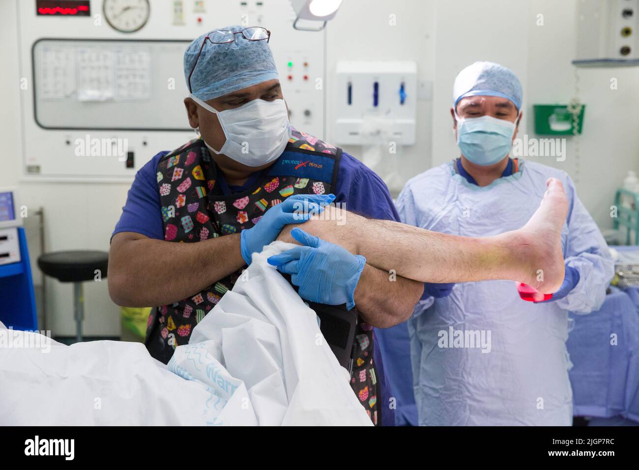 Hospital staff prepare a patient for foot surgery. The NHS is under