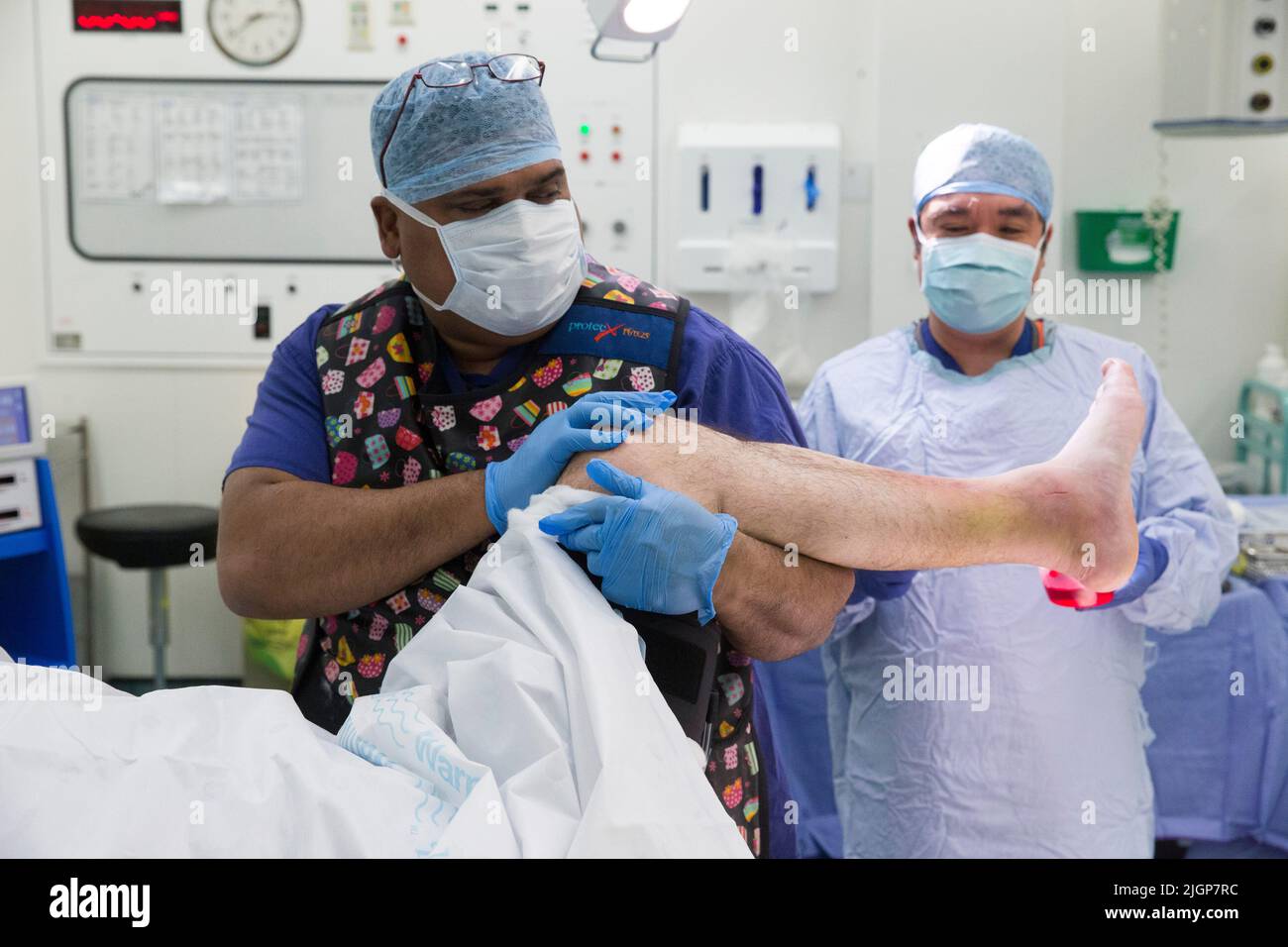 Hospital staff prepare a patient for foot surgery. The NHS is under pressure following severe cuts and staff shortages. Stock Photo