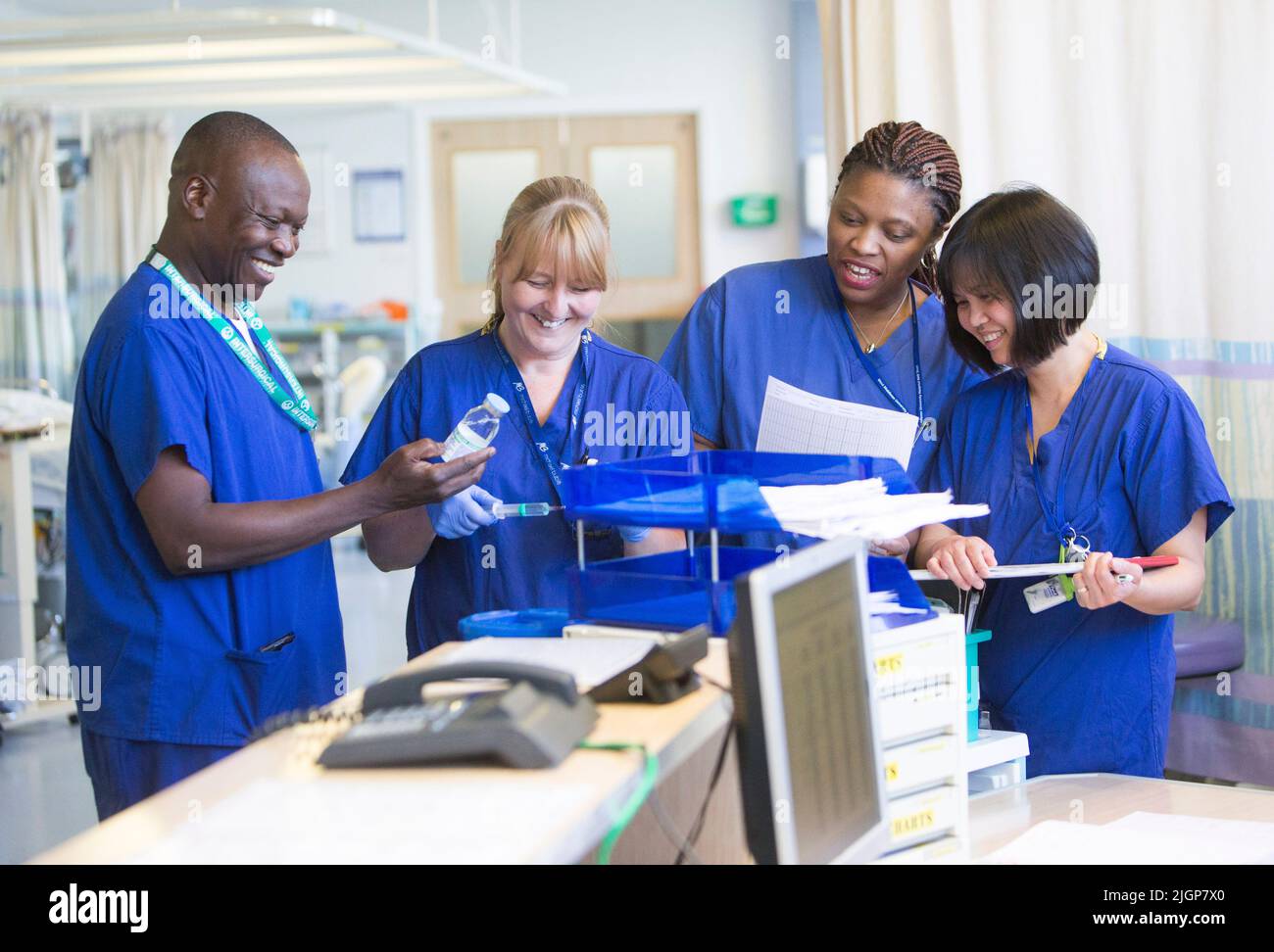 Hospital staff at a workstation on an NHS ward. The NHS is under severe pressure due to staff shortages and pay freezes. Stock Photo