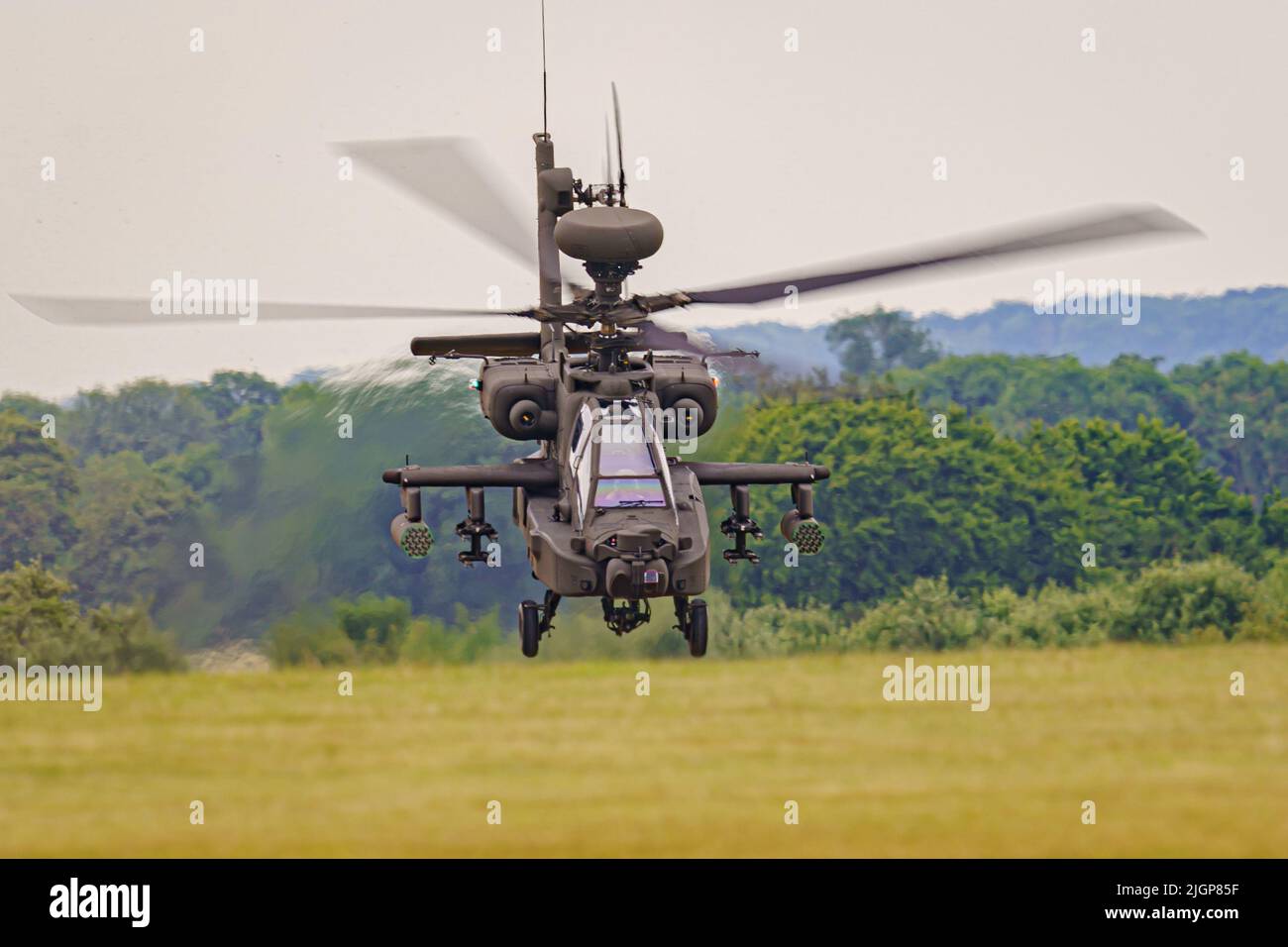 The Army Air Corps latest Apache AH-64E attack helicopter performs maneuvers over open countryside at the Army Aviation Centre at Middle Wallop, Stockbridge in Hampshire. Picture date: Tuesday July 12, 2022. Stock Photo