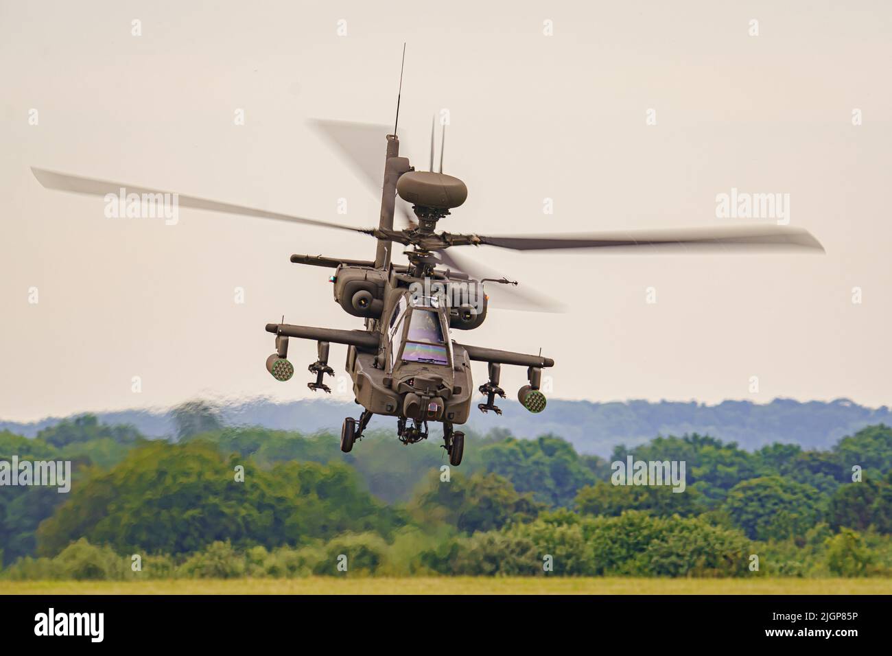 The Army Air Corps latest Apache AH-64E attack helicopter performs maneuvers over open countryside at the Army Aviation Centre at Middle Wallop, Stockbridge in Hampshire. Picture date: Tuesday July 12, 2022. Stock Photo