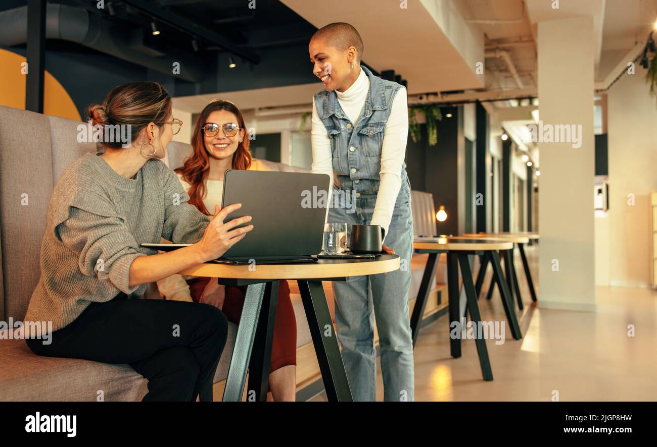 Group of young businesswomen working together in an office lobby. Three ...