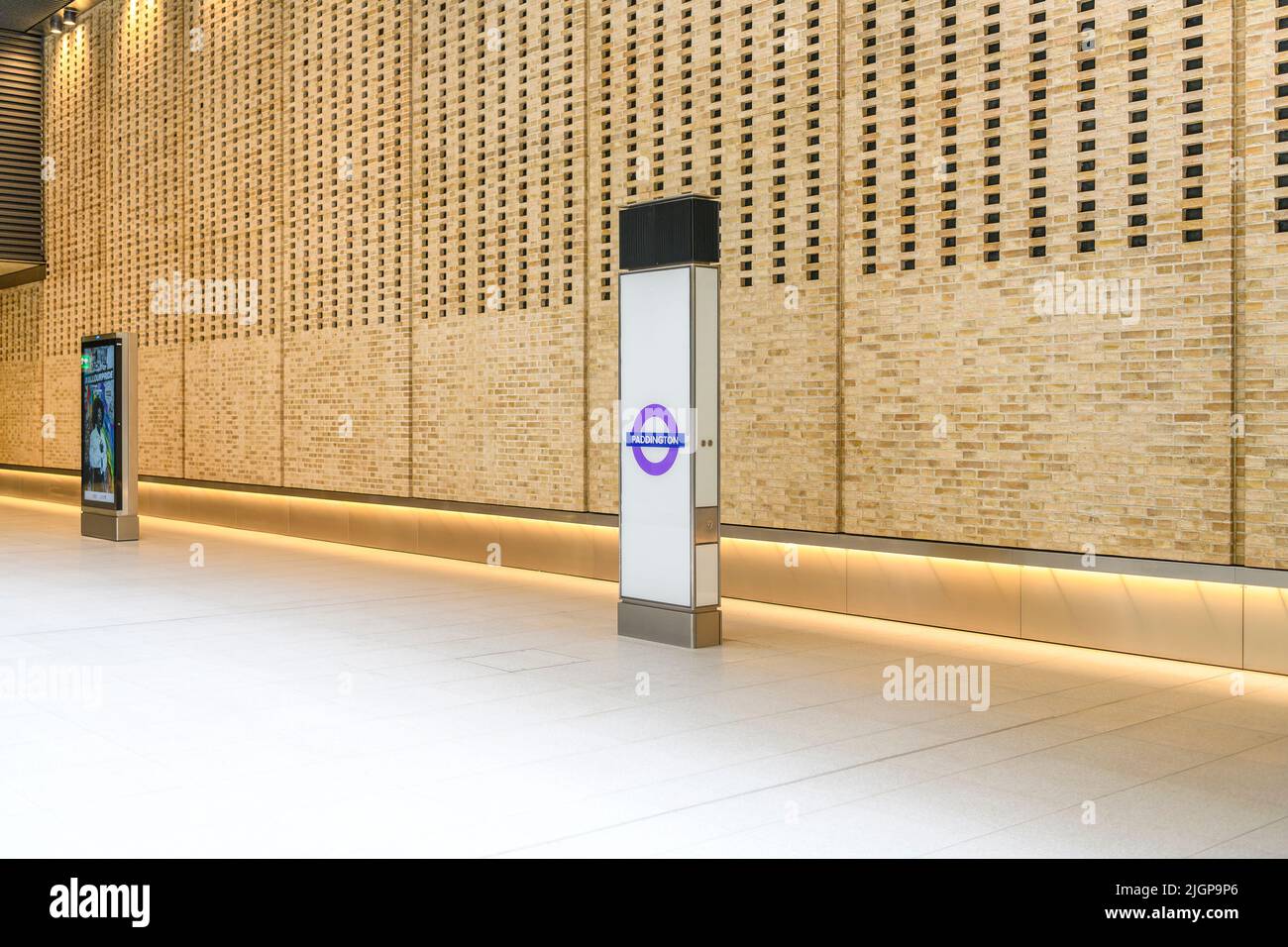 Entrance hall of Paddington station on the new Elizabeth Line underground in London. With a dramatic wall of punched brickwork. Stock Photo